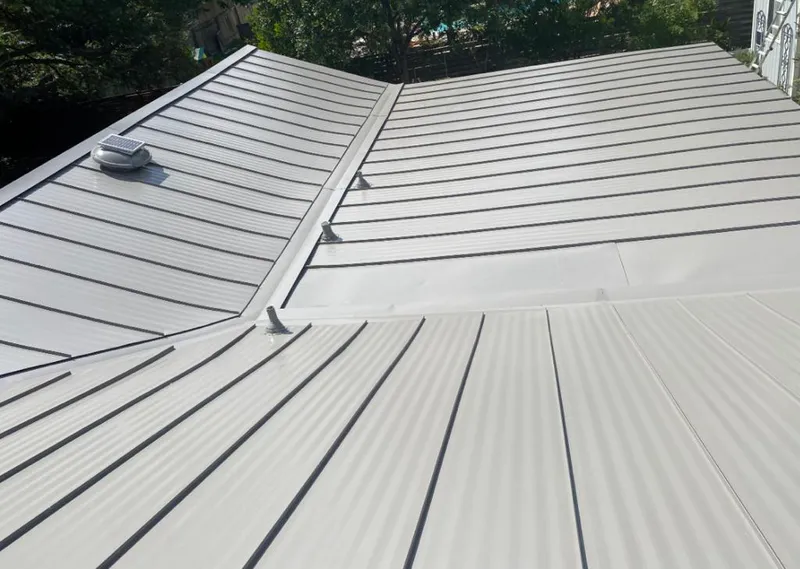Solar attic fan installed on a metal roof for Roof Ventilation in Oxford